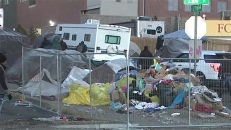 Crews sweep large encampment as more migrant buses arrive in Denver